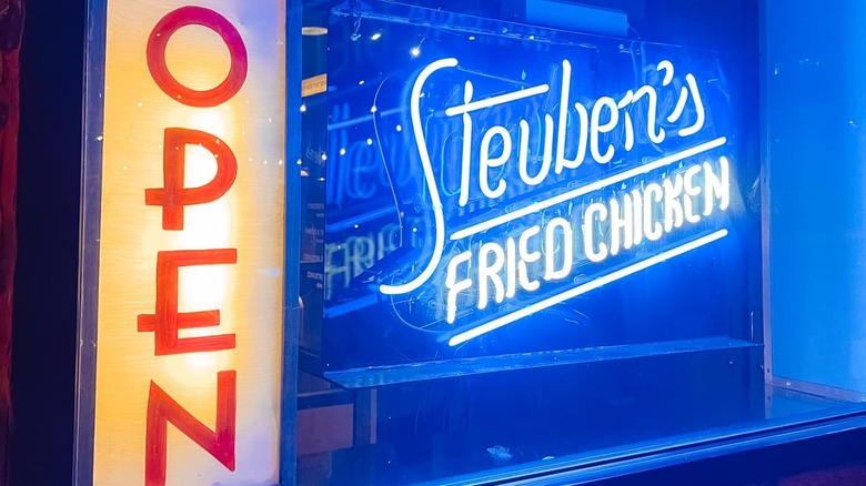 Neon sign saying Open and Steuben's fried chicken