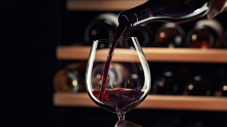 Red wine pouring into glass