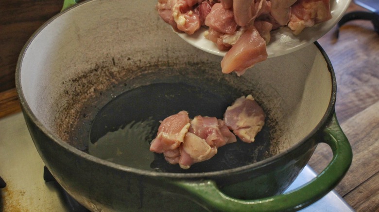 cooking chicken pieces in pot