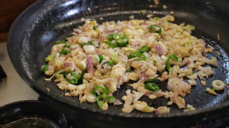 onions and chilis in pan