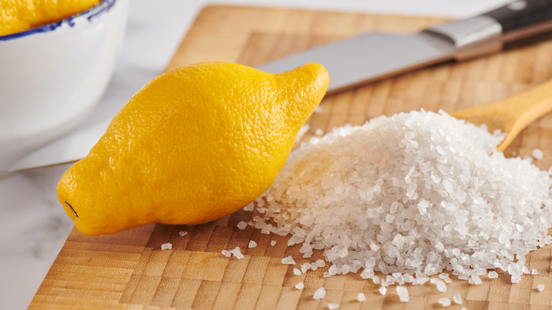 lemon and salt on cutting board