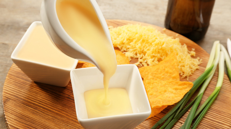 Pouring beer cheese sauce into bowl