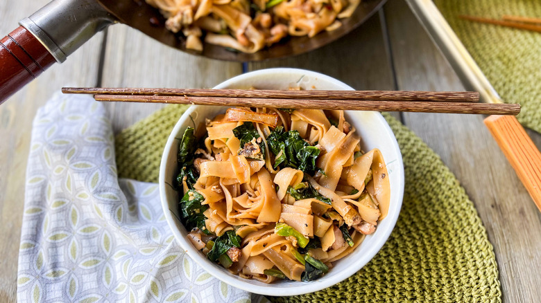 chicken pad see-ew with chopsticks