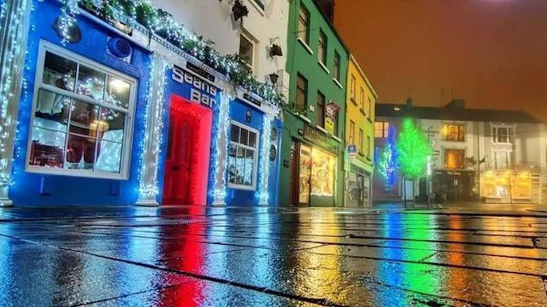 Outside Sean's Bar at night with colorful lights