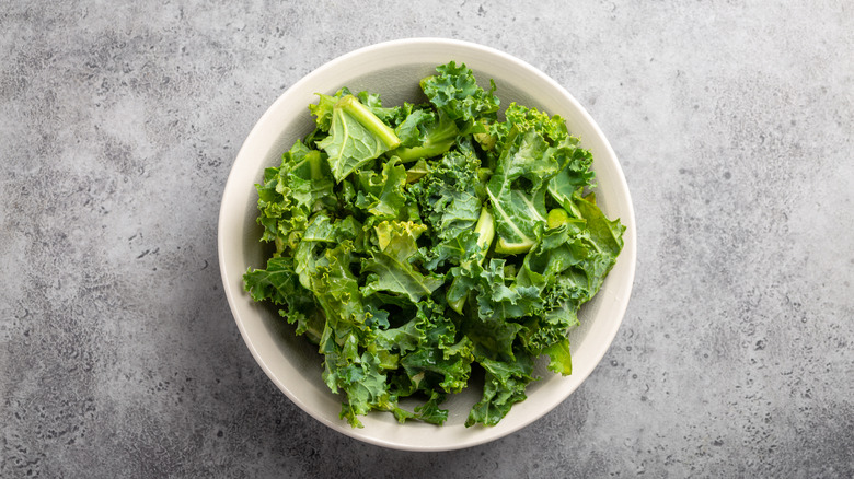 bowl of chopped kale on marble table