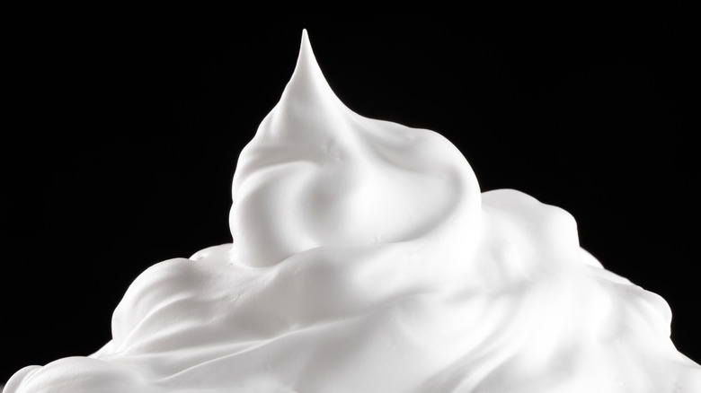 whipped cream peak against a black background