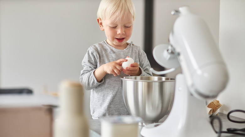 child in front of a KitchenAid mixer