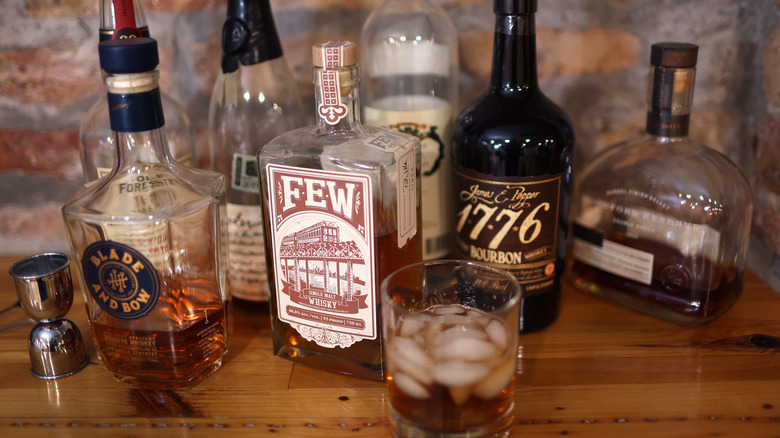 American whiskey bottles on wood shelf