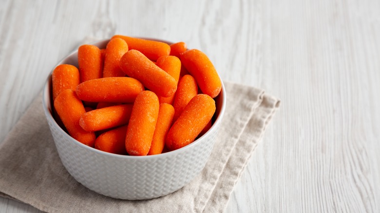 White ramekin of baby carrots