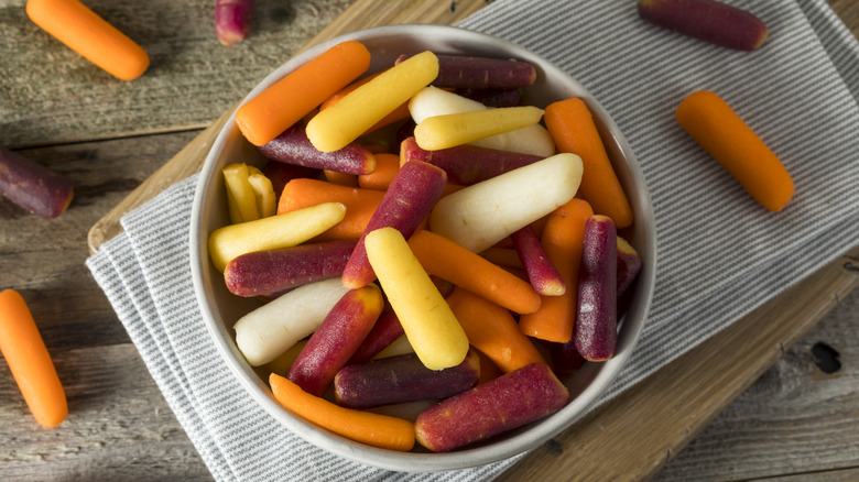 rainbow baby carrots on striped dishcloth