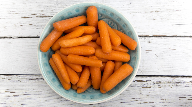 Baby carrots in a blue bowl