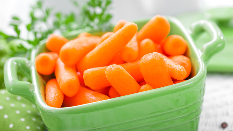 Baby carrots in a green ramekin