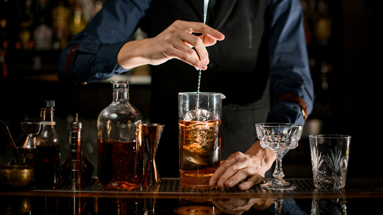 Bartender stirring liquor in a beaker