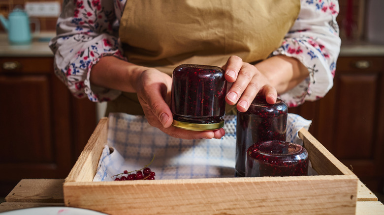 Home cook holding jar of jam upside-down