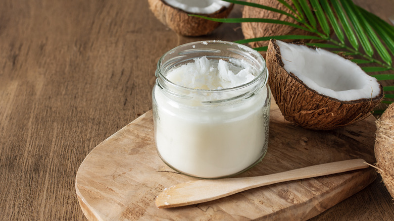 Jar of coconut oil and fresh coconut