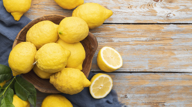 A bowl of lemons on a table