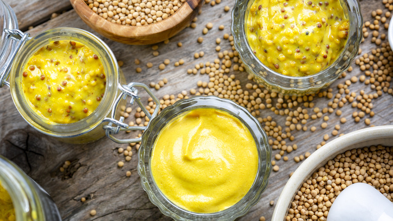 Jars of mustard and mustard seeds