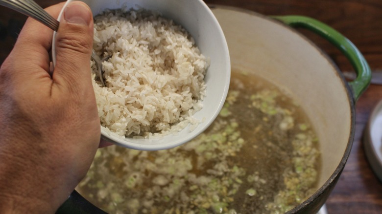 adding rice into shrimp broth