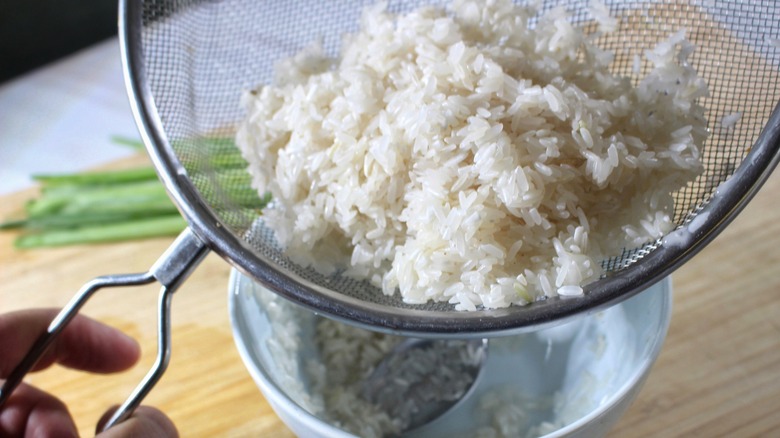 draining rice in sieve