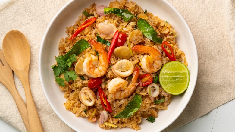 Spicy Tom Yum seafood fried rice with shrimp and lime