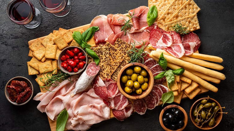 Cured meats with cheeses, olives, wine