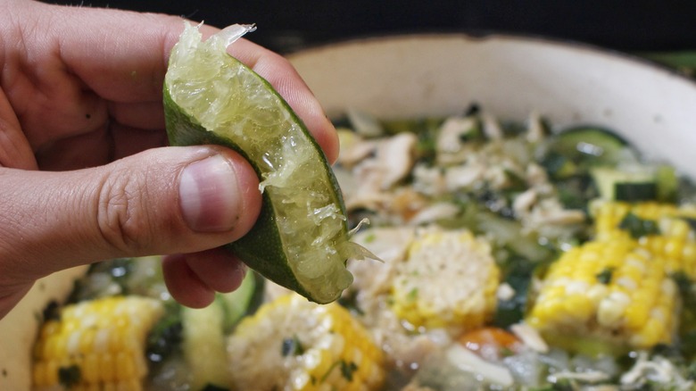 squeezing lime into soup
