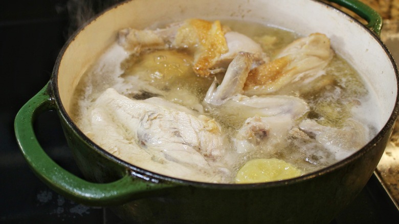 simmering chicken bone broth in pot