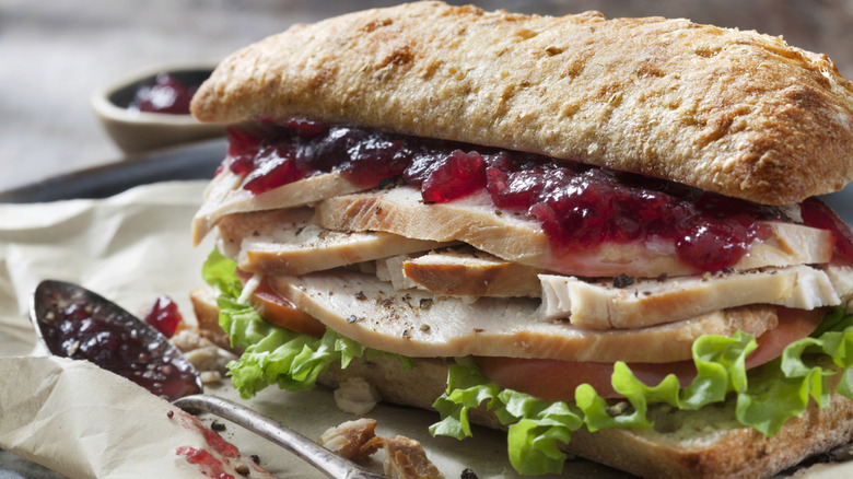 Turkey sandwich with cranberry sauce.