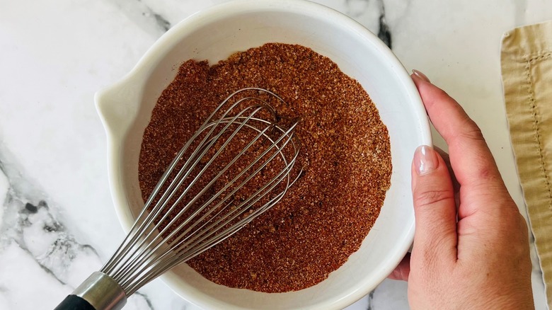 whisk and seasoning in bowl