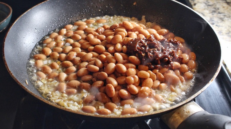 refried beans ingredients in skillet