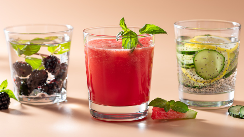 Three beverages made with fruit and cucumbers