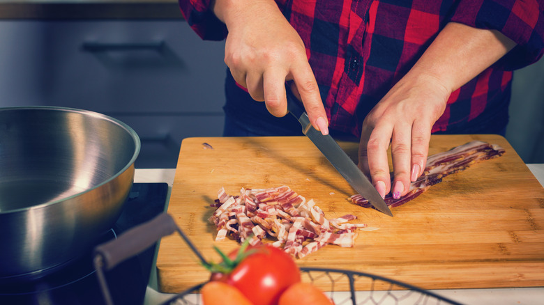 Woman chopping bacon