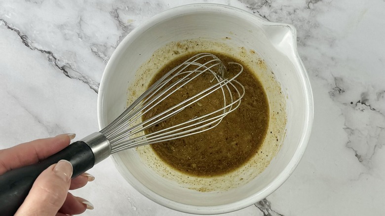 hand stirring salad dressing