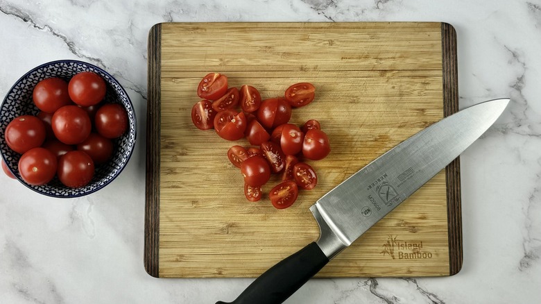 chopped cherry tomatoes with knife