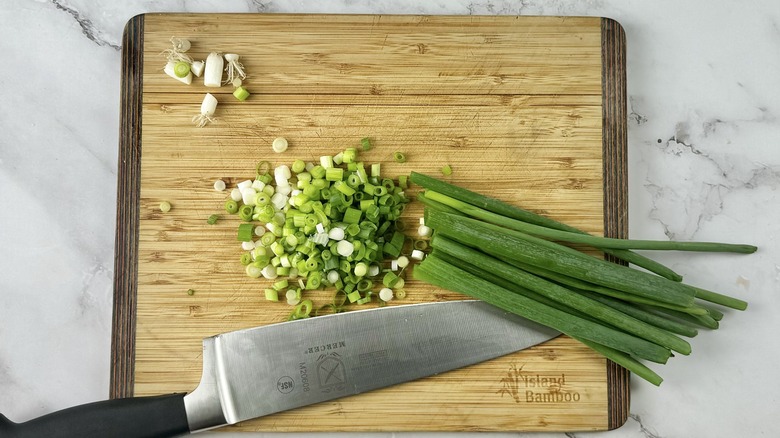 chopped green onions with knife