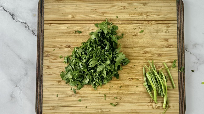 chopped cilantro on wooden board