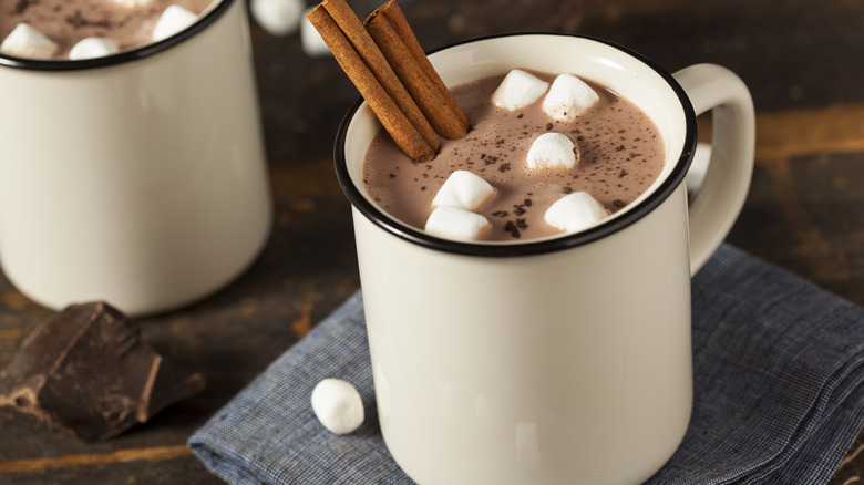 Hot chocolate drink with marshmallows and cinnamon sticks