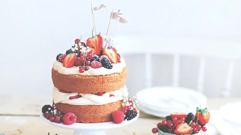 white cake with berries