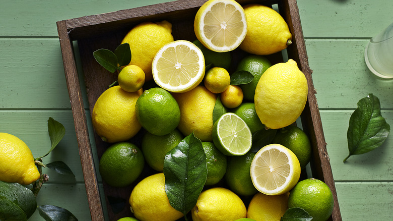 Crate of whole and sliced lemons and limes