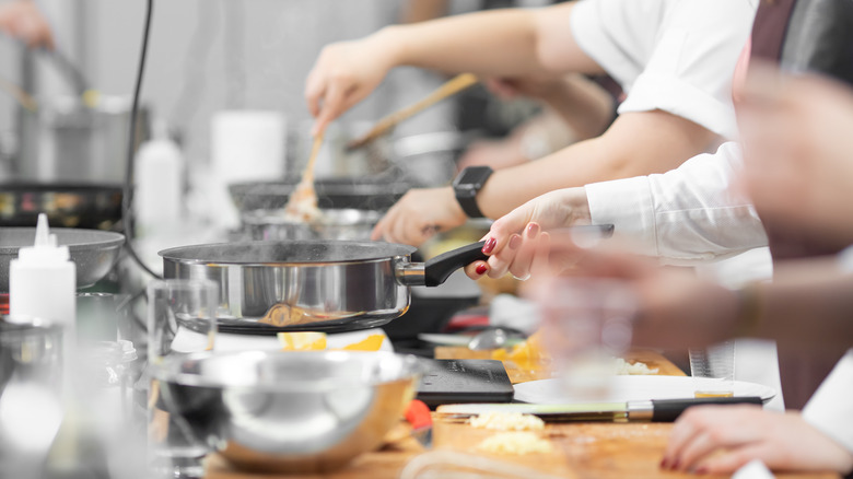 Cooks at their kitchen stations