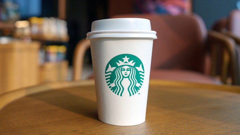 white Starbucks paper cup on wooden table