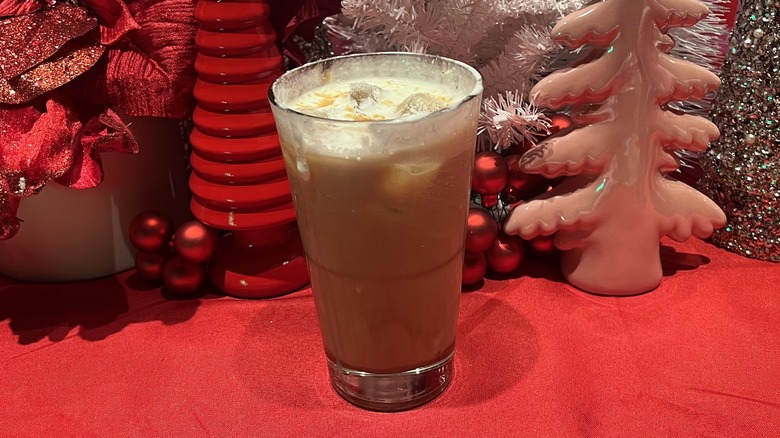 Starbucks iced caramel brulee latte in front of a holiday-themed background