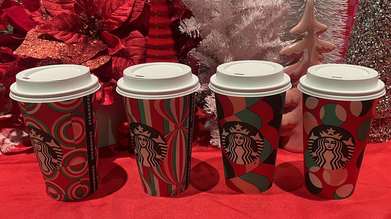 Starbucks holiday cups with holiday themed background