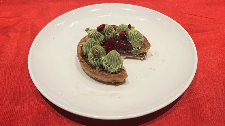 Pistachio Raspberry Tart on a festive table setting