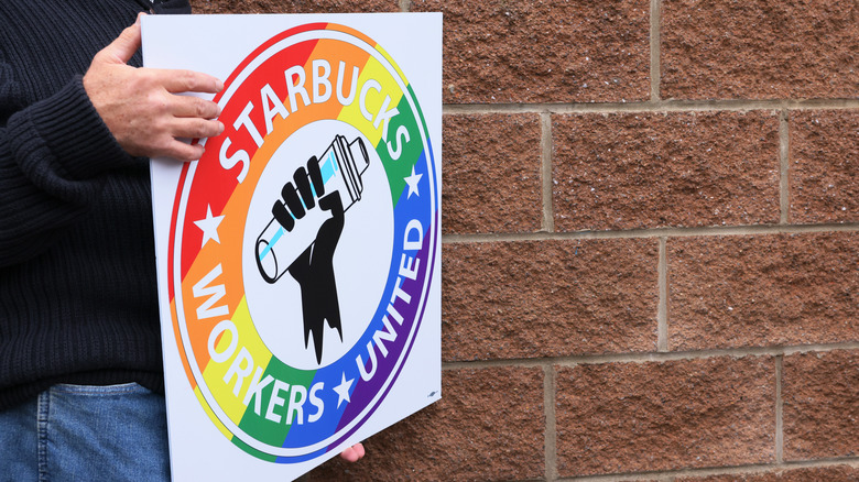 Person holding union rainbow sign