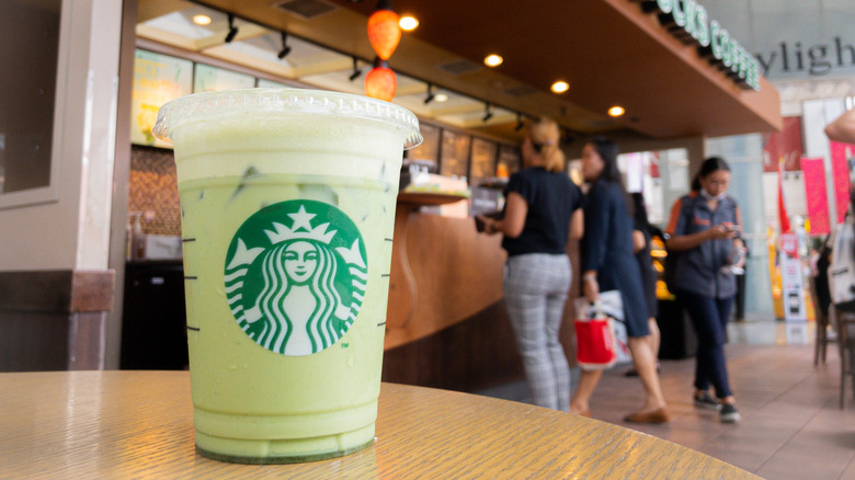 Cup of Starbucks iced matcha green tea latte on a store table