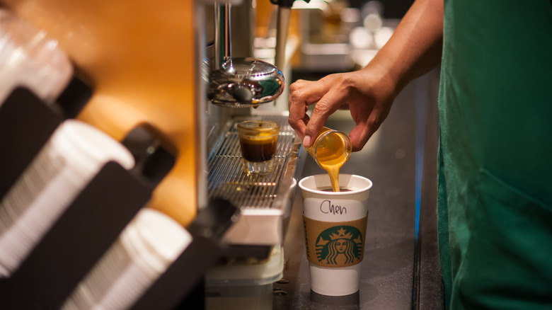 Starbucks barista making a coffee