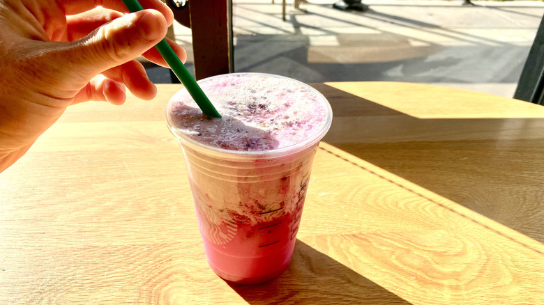 Stirring Starbucks Glinda's Pink Potion with straw