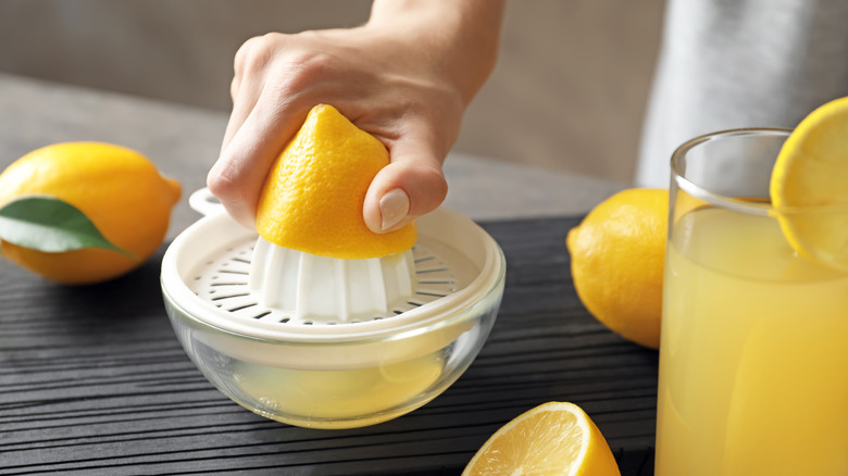 Hand using juicer for lemons