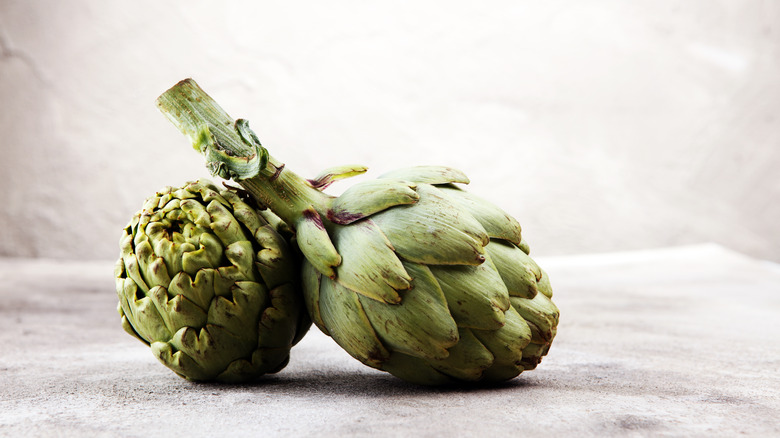 Artichoke with stem on gray background